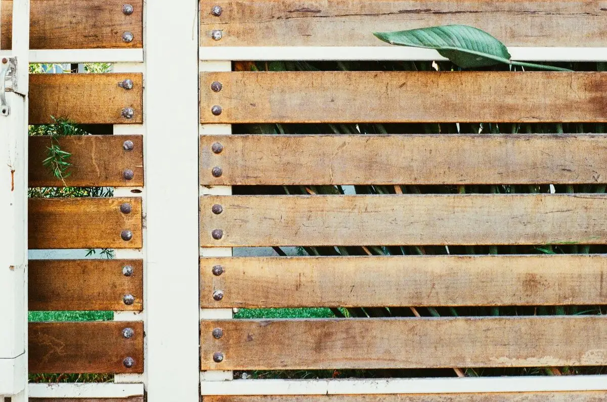 Horizontal timber slat fence with white posts