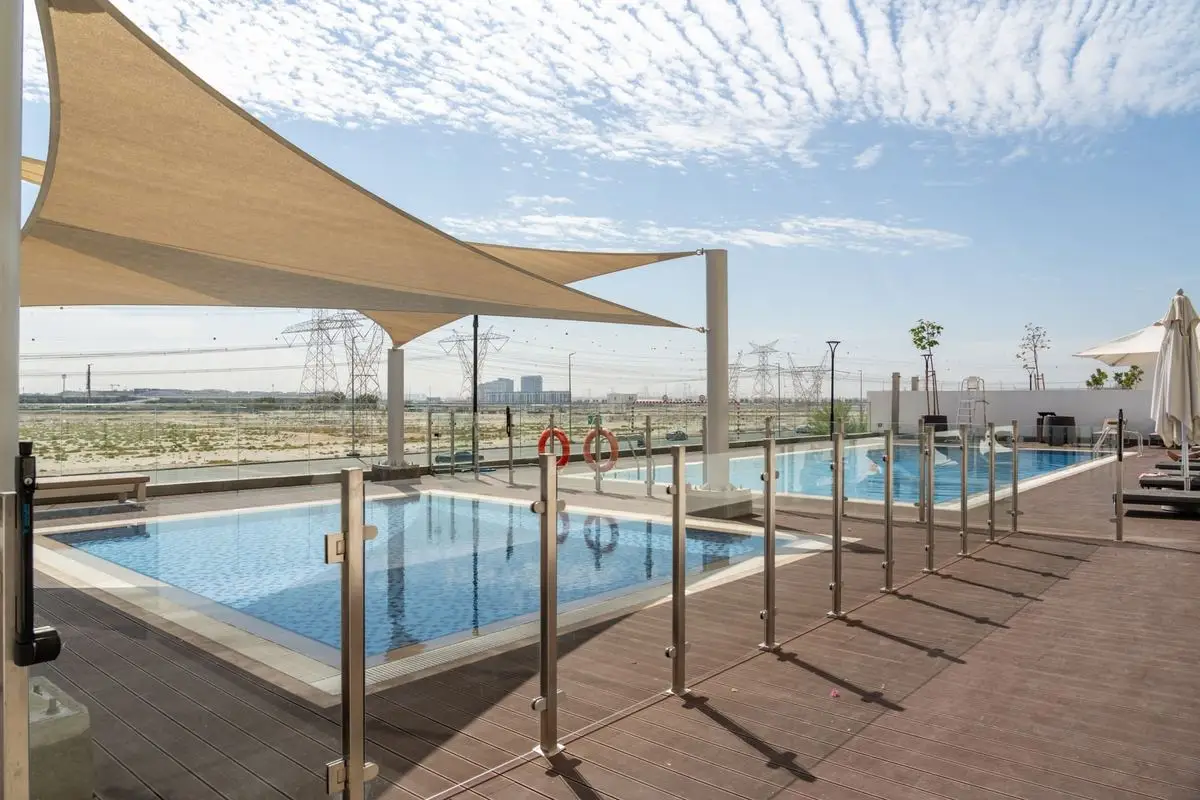 Glass pool fence with stainless posts beside a pool
